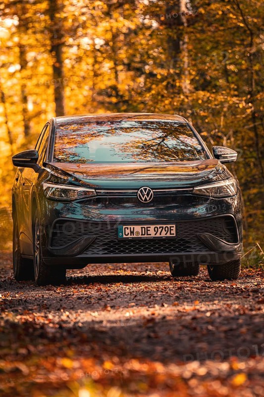 Car in autumn forest with golden leaves, electric car VW ID5, Gechingen, Black Forest, Germany, Europe