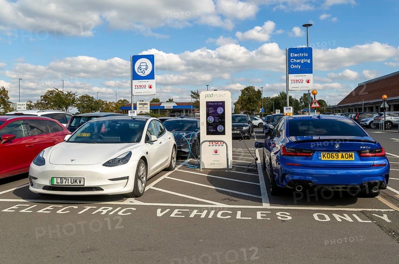 Electric vehicles charging Pod Point, Tesco Extra supermarket carpark, Swindon, Wiltshire, England, UK