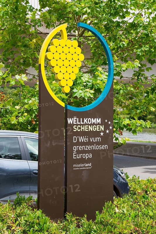 Welcome sign for Schengen with a graphic grape motif and green background, Schengen, Canton of Remich, Grand Duchy of Luxembourg