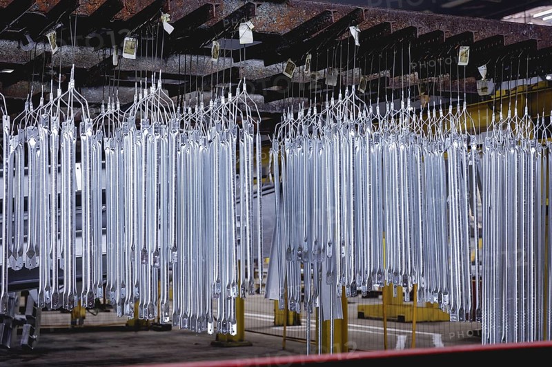 Finished galvanised steel parts lie in the factory hall of a surface finishing factory of the Coatinc Company in Siegen, 22.08.2024