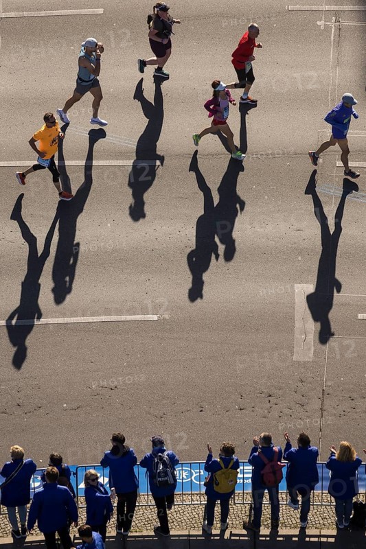 Marathon runners and their shadows at the 50th BMW Berlin Marathon 2024 on 29 September 2024