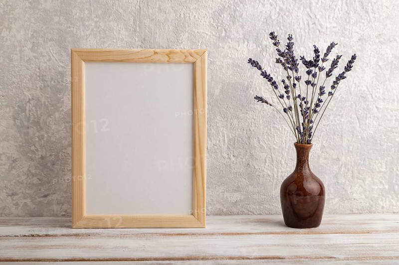 White wooden frame mockup with lavender in ceramic vase on gray concrete background. Blank, vertical orientation, still life, copy space