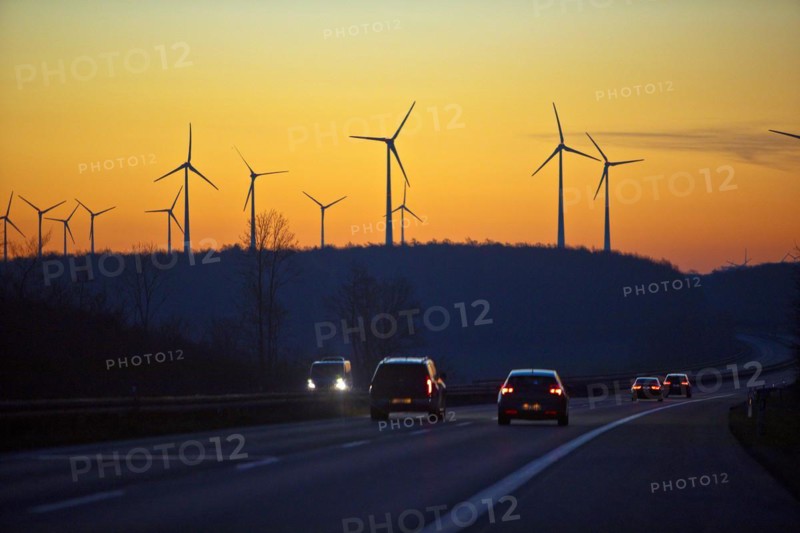 Wind turbines at sunrise with cars on the A 44 motorway, Büren, Paderborn plateau, North Rhine-Westphalia, Germany, Europe