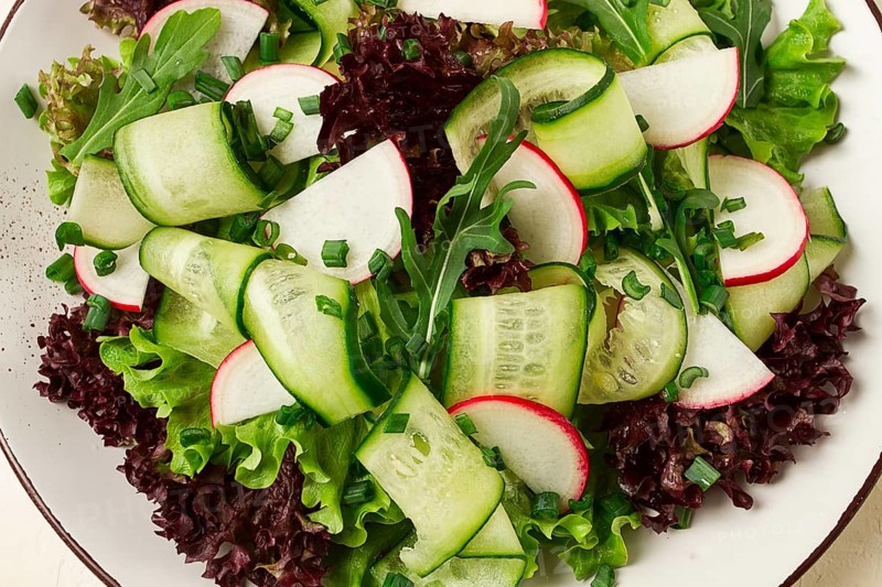Vegetable salad, radishes and cucumbers, radish micro-greens, lettuce leaves, green onions, homemade, no people