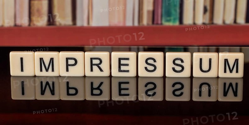The word in the IMPRINT written with letter cubes in front of a bookshelf