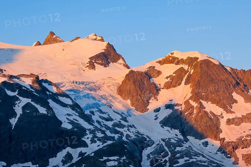 First light hits summit of Hinter Tierberg, Mittler Tierberg and Vorder Tierberg, with Steingletscher in the canton of Bern, Switzerland, Europe