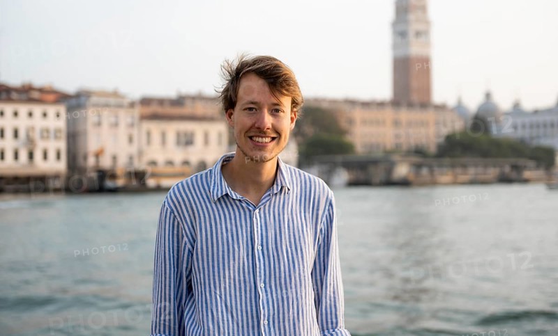 Young man in striped shirt, portrait, on the banks of the Grand Canal, behind Campanile, Venice, Veneto, Italy, Europe