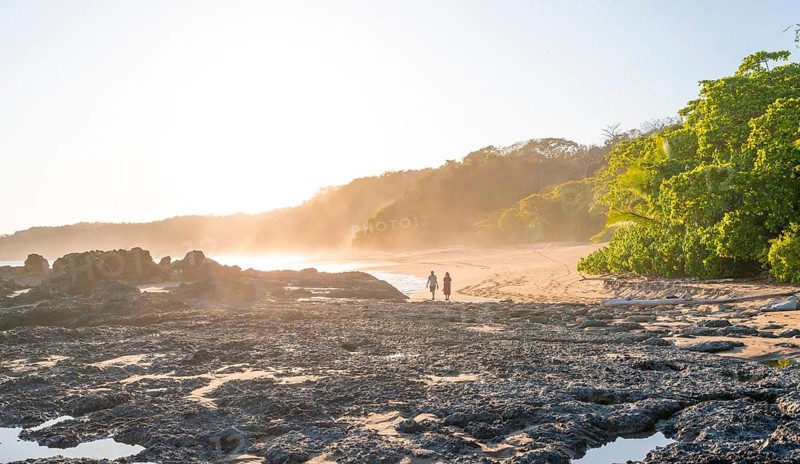 Two people on a sandy beach at sunset, Playa Cocalito, coastal landscape, Pacific coast, Nicoya Peninsula, Puntarenas Province, Costa Rica, Central America