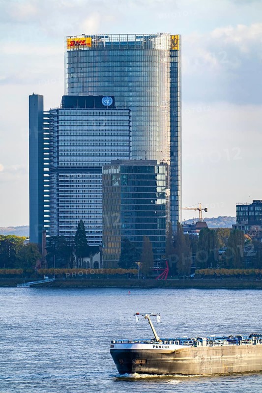 Skyline Bonn on the Rhine, in front the UNFCCC Secretariat of the Framework Convention on Climate Change, in the centre the high-rise building of the United Nations, Campus Bonn, behind it the Posttower, corporate headquarters of Deutsche Post, cargo ship, North Rhine-Westphalia, Germany, Europe