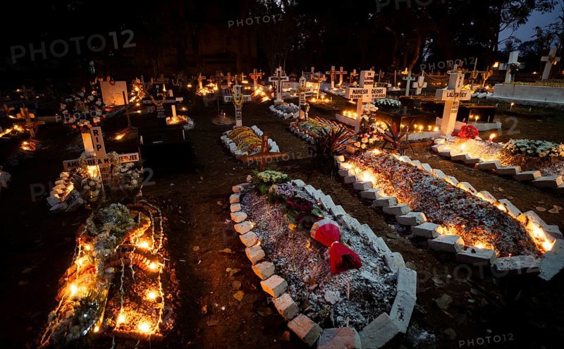 People from Christian community light candles and offer prayers on the grave of their relative during the All souls day observation, in Guwahati, India on 2 November 2024. All Souls' Day is a Christian holiday dedicated to honoring and praying for the souls of the departed