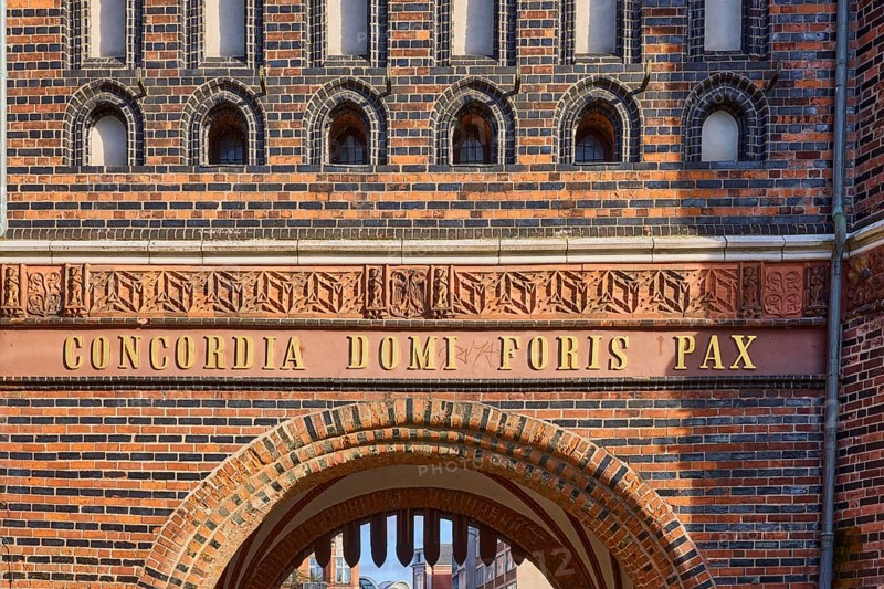 City gate Lübeck Holstentor, inscription Concordia domi foris pax with the meaning harmony inside peace outside, Hanseatic city of Lübeck, independent city, Schleswig-Holstein, Germany, Europe