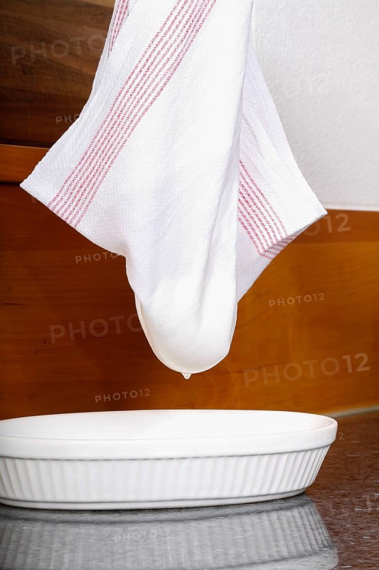 Swabian cuisine, preparation of Luggeleskäs, draining Swabian cream cheese, dish towel, dairy product, vegetarian, healthy, grandmother's cooking, regional, home cooking, typical Swabian, traditional cuisine, food photography, studio, Germany, Europe