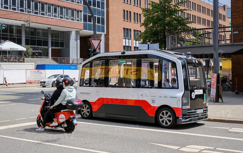 Hamburg, Germany - Autonomous elevated railway electric bus and an Emmy electric scooter in Hamburg's Hafencity