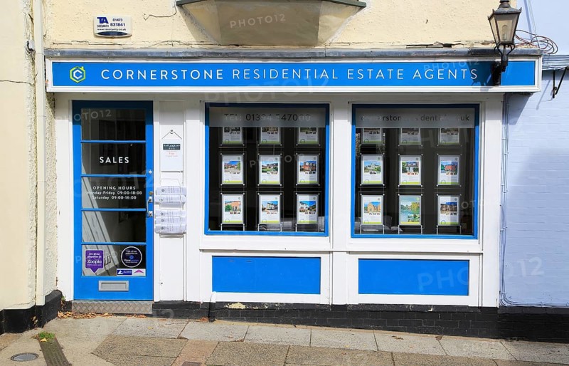 Cornerstone estate agent shop window Market Hill, Woodbridge, Suffolk, England, UK