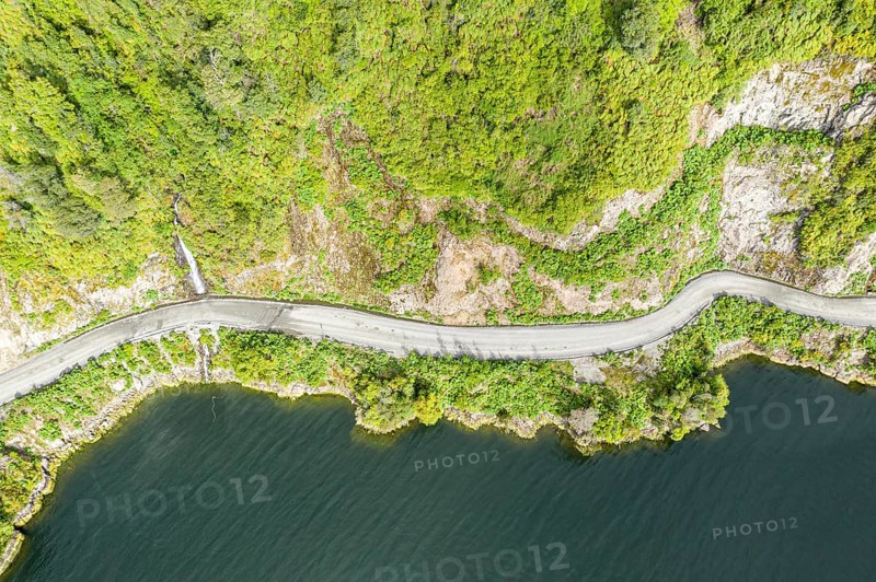 Road Carretera Austral winding along the fjord south of village Puyuhuapi, Patagonia, Chile, South America