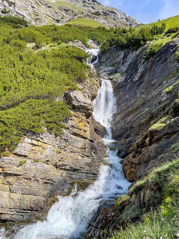 Waterfall in the Braulio valley Cascata del Braulio with little water in midsummer alpine summer in the Alps, Valdidentro, province of Sondrio, Lombardy, Italy, Europe