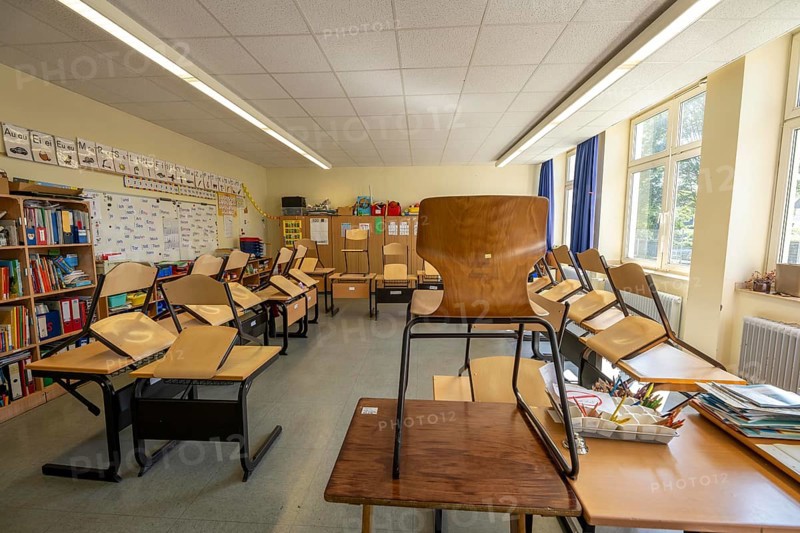 Classroom of a fourth grade, after school, the building is older but in good condition, modern teaching materials
