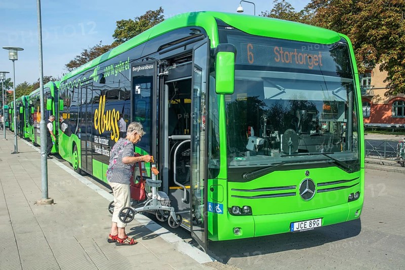 Elderly woman boards an electric bus in Ystad, Skåne County, Sweden, Scandinavia, Europe
