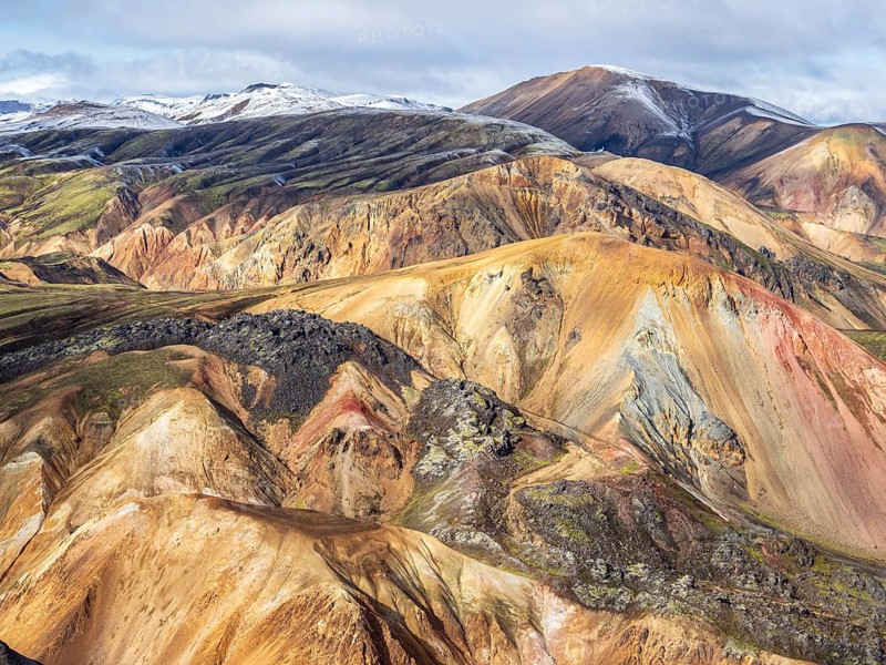Early snow on the colorful rhyolite mountains, mt. Brennisteinsalda, lava fields, Landmannalaugar, Fjallabak Nature Reserve, Iceland, Europe