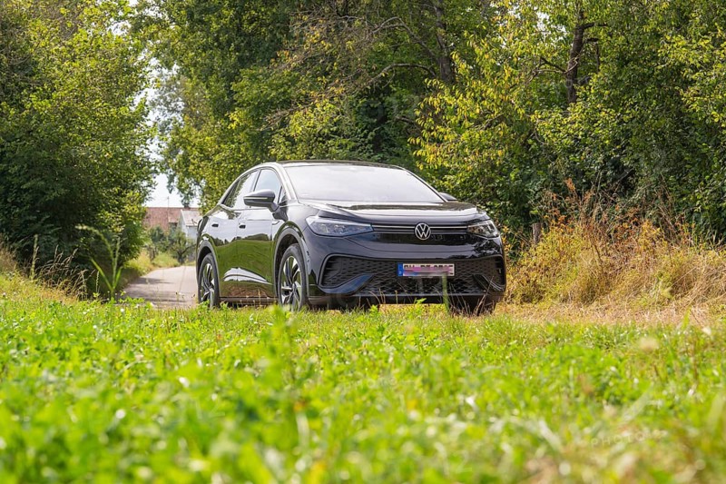 Black SUV parked on a rural road, surrounded by lush vegetation and summer atmosphere, VW ID5 electric car, Calw, Black Forest, Germany, Europe