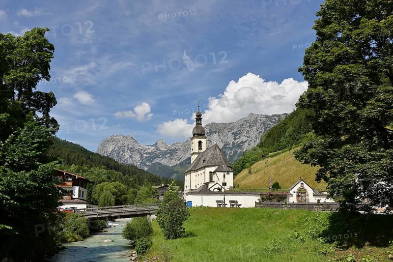 Parish church of St. Sebastian in autumn with Ramsauer Ache, Reiteralpe in the background, Ramsau, Berchtesgaden, Berchtesgadener Land, Upper Bavaria, Bavaria, Germany, Europe