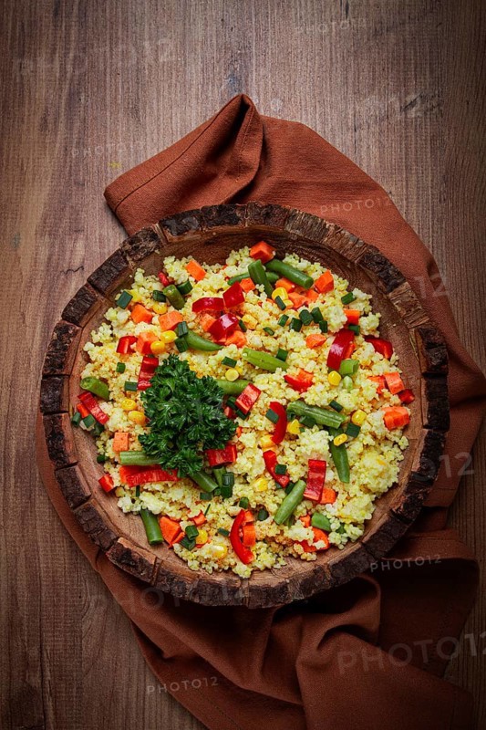 Couscous with vegetables, paprika, carrots, string beans, corn, homemade, top view, no people