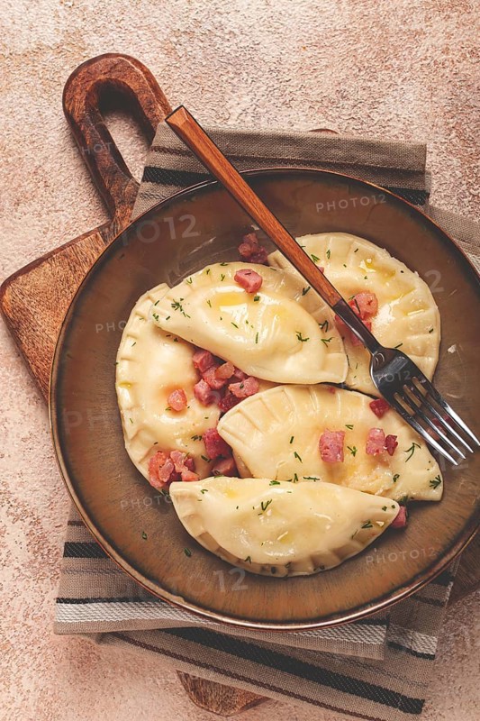 Dumplings, with fried prosciutto, a traditional dish of Polish cuisine, dumplings, top view, close-up, without people