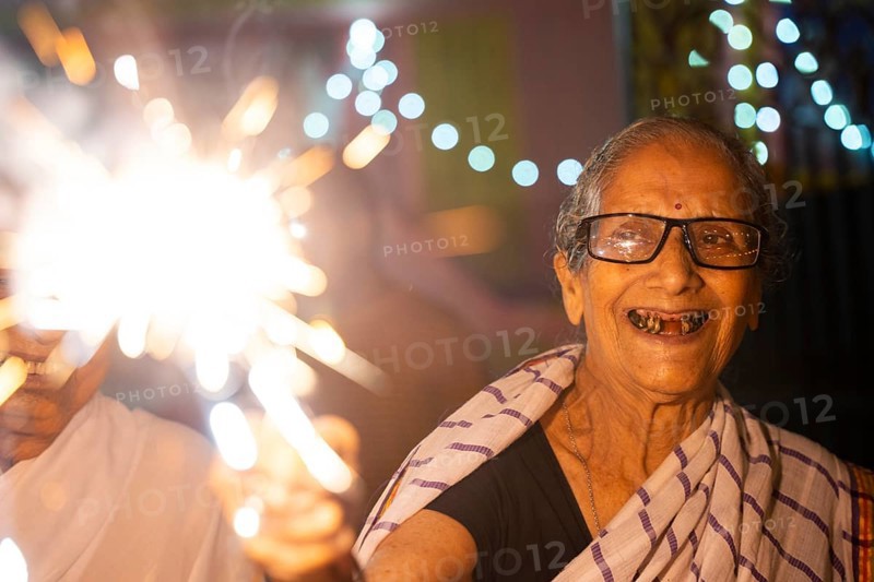 An elderly woman of Pramod Talukdar Memorial Old Age Home burn sparkler crackersas she celebrate Diwali, in Guwahati, India on 1 November 2024. Diwali, also known as the Festival of Lights, is one of the most widely celebrated Hindu festivals, symbolizing the victory of light over darkness and good over evil