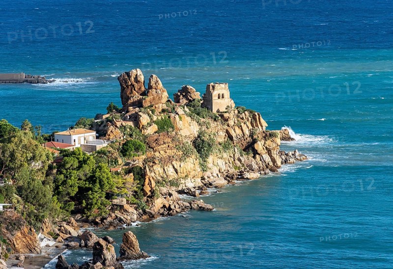 Ruins of Torre Caldura Castle on a rocky promontory jutting into the sea near Cefalu, Sicily, Italy, Europe