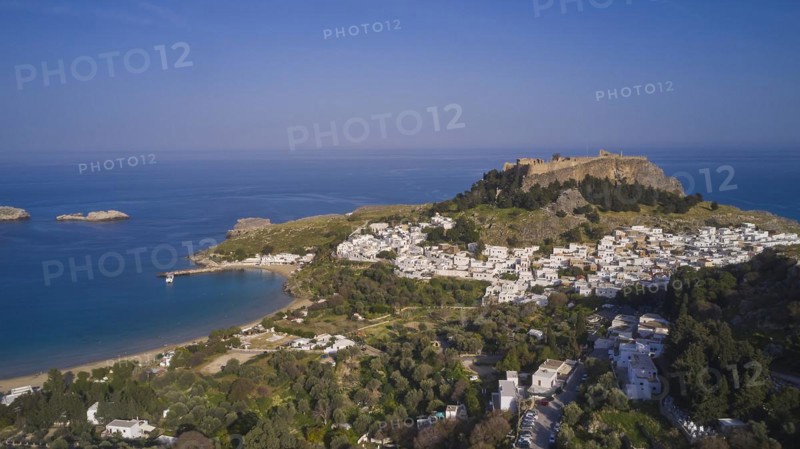 Drone shot, Lindos, Acropolis of Lindos, late afternoon light, view of a village with a fortress on a hill next to a beach bay, Archaeological site, Lindos, Rhodes, Dodecanese, Greek Islands, Greece, Europe