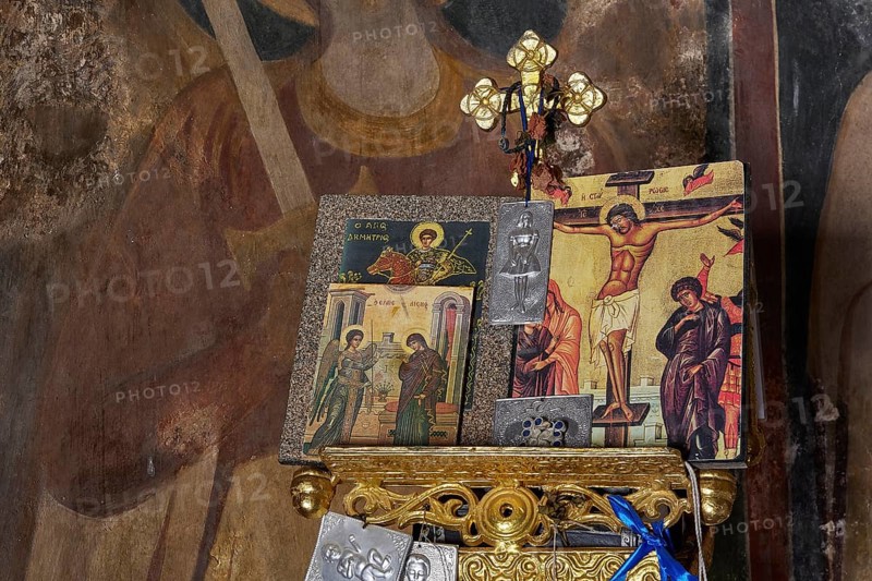 Close-up of an altar with icons and a crucifixion symbol in a church, wall paintings are visible in the background, Byzantine chapel Agios Nikolaos Foundoukli, between Eleousa and Profitis Ilias, Rhodes, Dodecanese, Greek Islands, Greece, Europe