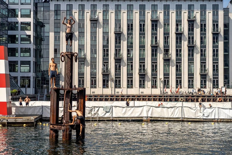 Young people diving into the harbour, Fisketorvet harbour swimming pool in Copenhagen, Denmark, Europe
