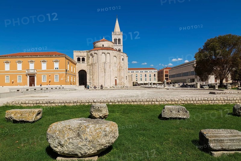Architectural remnants on display at Roman forum ruins with the church of Saint Donatus and Bell Tower of Zadar Cathedral, Zadar, Croatia, Europe