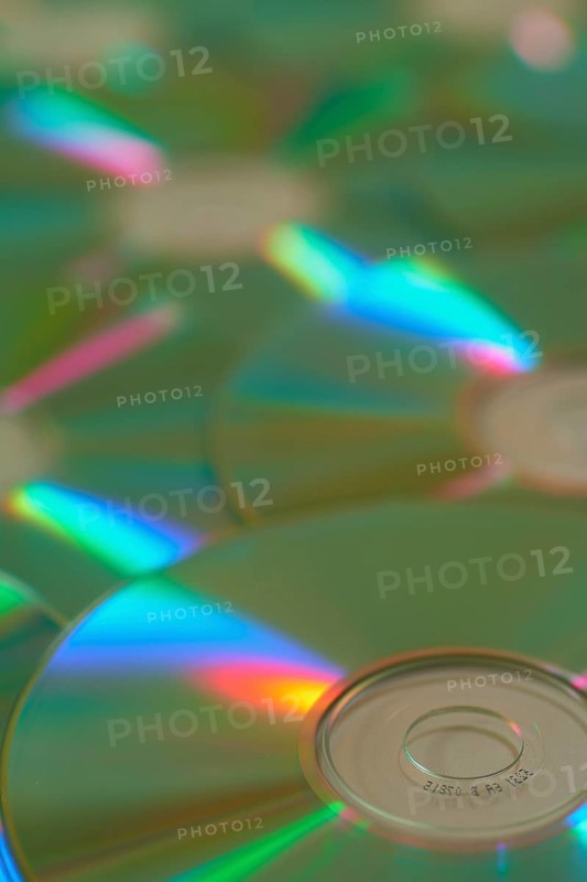 Several CD-ROMs with rainbow effect on the surface, close-up