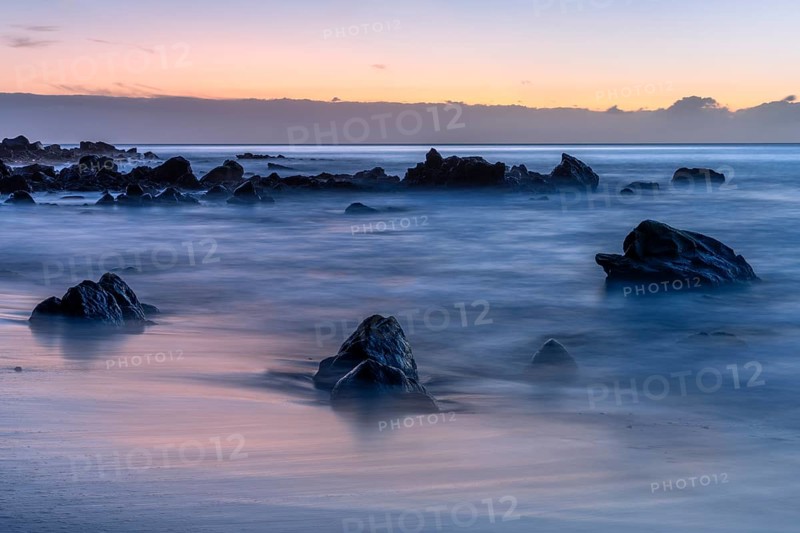 Rocks and sea on the beach of Playa del Inglés at sunset. Long exposure. Valle Gran Rey, La Gomera, Canary Islands, Spain, Europe