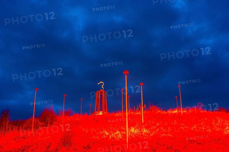 Rheinpreussen spoil tip in Mörs, spoil tip symbol Das Geleucht, light installation red illuminated slope, tower in the shape of a miner's lamp, dramatic sky, North Rhine-Westphalia, Germany, Europe