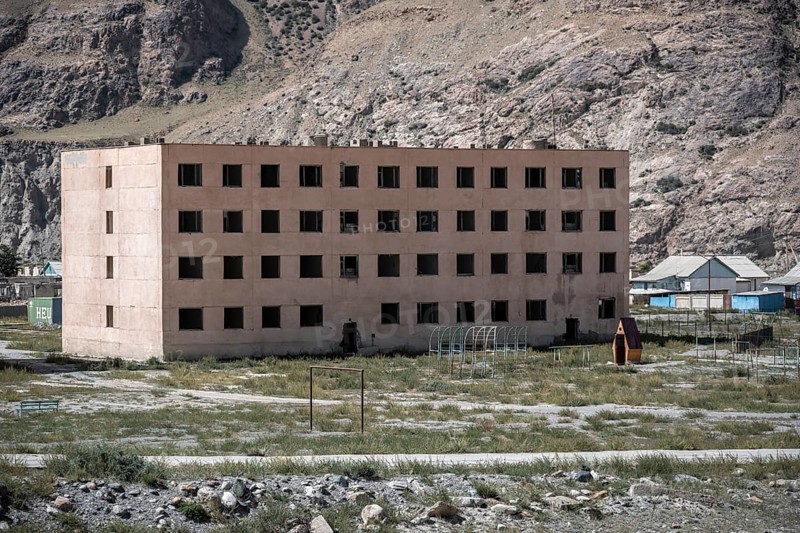 Abandoned, destroyed residential buildings, old Soviet apartment blocks in the ghost town, Engilchek, Tian Shan, Kyrgyzstan, Asia