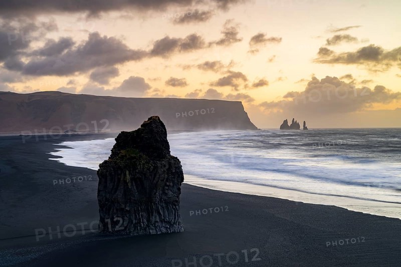 View from Cape Dyrhólaey at sunrise, rock formations Reynisdrangar and the mountain Reynisfjall, Vík í Mýrdal, Suðurland, Iceland, Europe