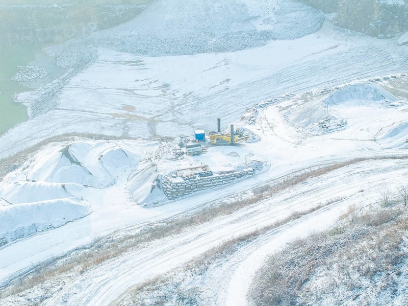 Detailed view of a snow-covered area in a quarry with excavators, Nagold, Black Forest, Germany, Europe