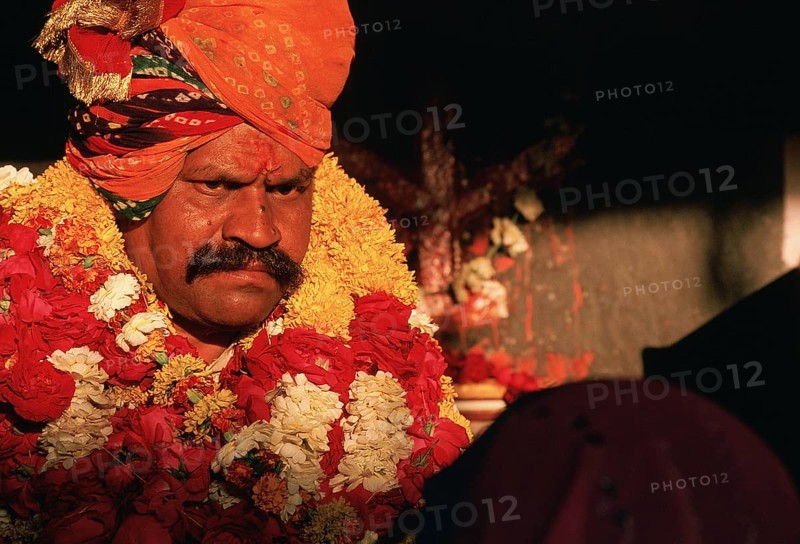 Healing session led by a hindu man, portrait of a traditional healer at work, Chittorgarh, Rajasthan, India. He cures by invoking the spirits of Jaimal and Phatta, two teenage boys who fought against the army of the Mughal emperor Akbar in 1568 at Chittorgarh. Both died on the battlefield and are now considered as heroes. Both belonged to the Rajput class, the noble class in western India. The healer himself is Rajput