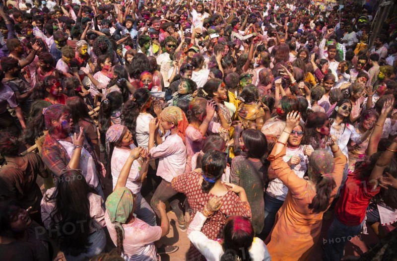 Revellers dancing in the beat of music as they celebrate Holi on a street, the Hindu spring festival of colours on March 25, 2024 in Guwahati, Assam, India. Holi, also known as the Festival of Colors or the Festival of Spring, is one of the most vibrant and joyous festivals in India