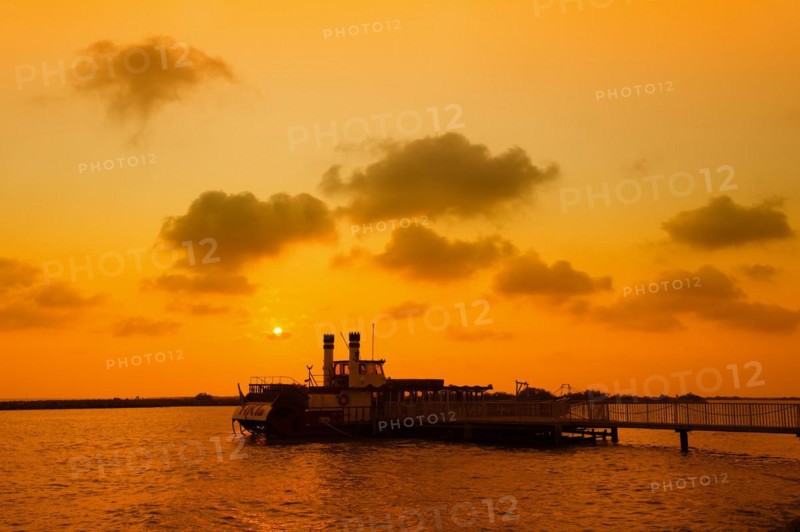 Paddle steamer Tiki III at the jetty at sunset, Les Saintes-Maries-de-la-Mer, Camargue, Provence, South of France