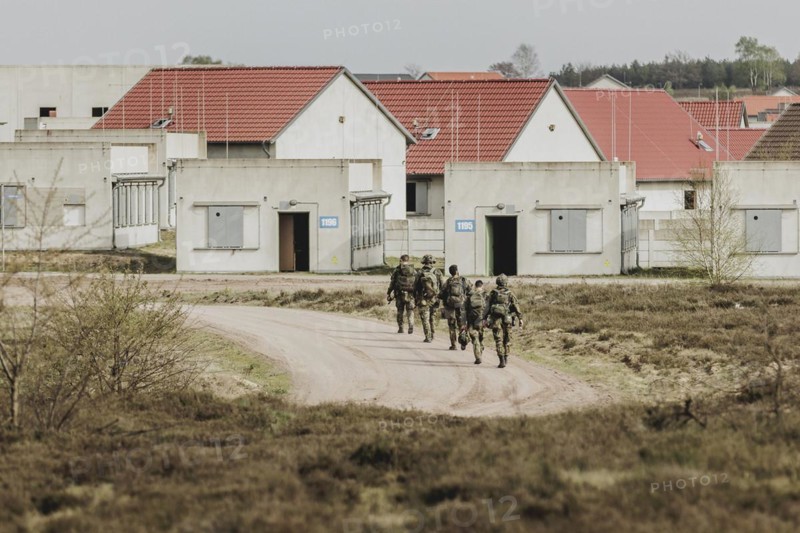 Soldiers walk into a training town, taken as part of a Bundeswehr exercise with armed forces from Norway and the Czech Republic during the 'Wettiner Schwert' exercise as part of Quadriga 2024 in the training town of Schnöggersburg, 8 April 2024