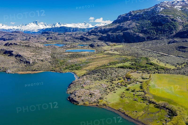 Farm at a lake near Puerto Ingeniero Ibanez, Mt. Cerro Castillo in the back, aerial view, Patagonia, Chile, South America