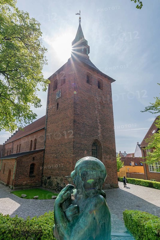 Svendborg Old Town, St. Nicolai Church, brick building, stepped gable, church tower, backlight, bronze figure, Fyn, Fyn Island, Denmark, Europe