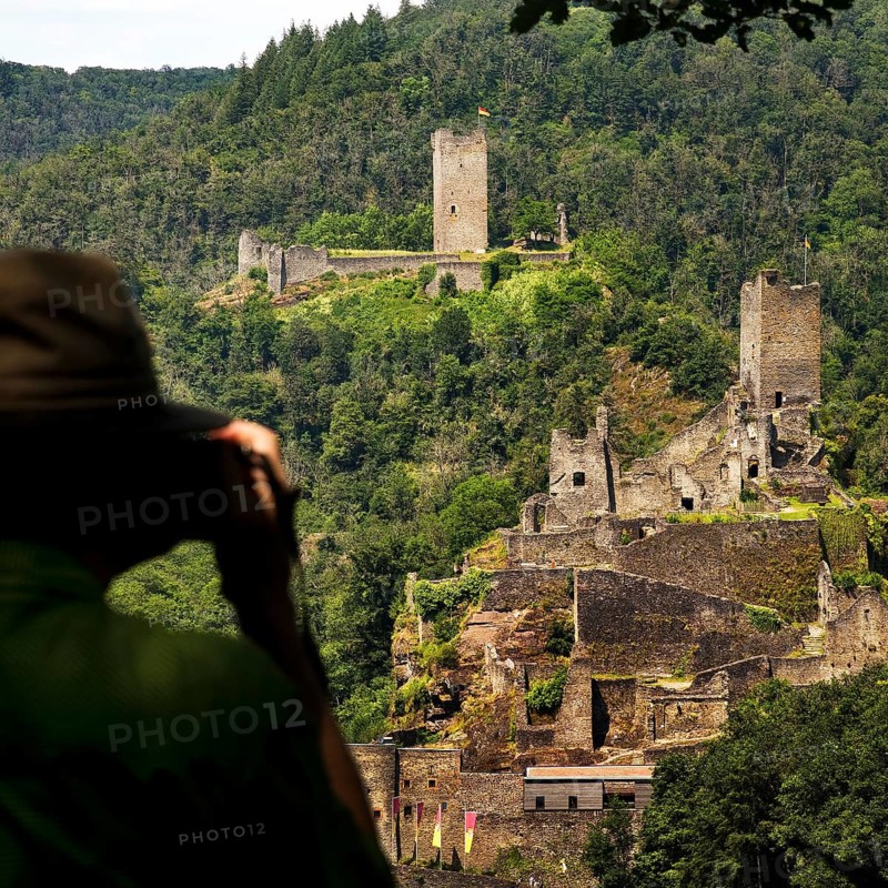 A man photographs the two castles, Oberburg and Niederburg of Manderscheid, South Eifel, Eifel, Rhineland-Palatinate, Germany, Europe