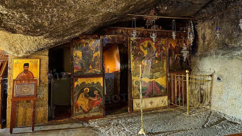 Orthodox church in a stone cave with iconostasis, sacred images and candles that create a spiritual atmosphere, rock grotto, Monastery tis Apokalipsis, Patmos, Dodecanese, Greek Islands, Greece, Europe