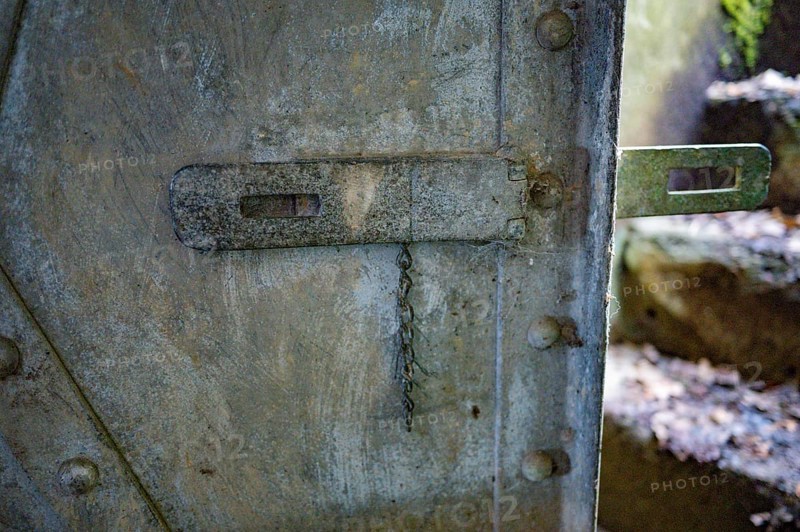 Bunker door Cheneux, 2nd World War, built 1933-1936, Ardennes offensive, heavy door weathered, a metal chain from the former castle hangs on it, the steps to the outside are visible on the right, blurred, Cheneux, Ardennes, Belgium, Europe