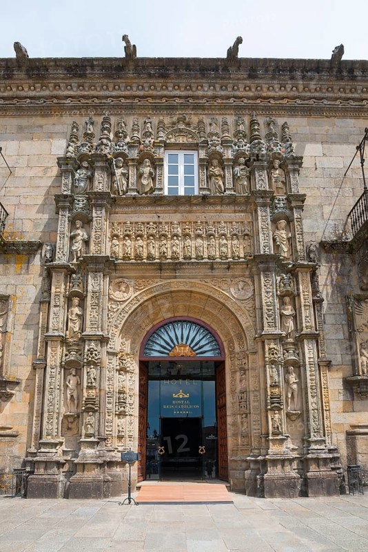 Entrance of a baroque building with richly decorated stone carvings and sculptures above the door, Hostal Reis Catolicos, Praza do Obradoiro, town square, Santiago de Compostela, autonomous community of Galicia, place of pilgrimage, destination of the Way of St James, Spain, Europe