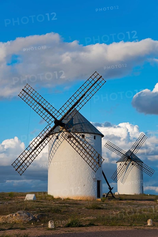 Two white windmills in a landscape under a blue sky and clouds in the background, Campo de Criptana, Ciudad Real province, Castilla-La Mancha, Route of Don Quixote, Spain, Europe